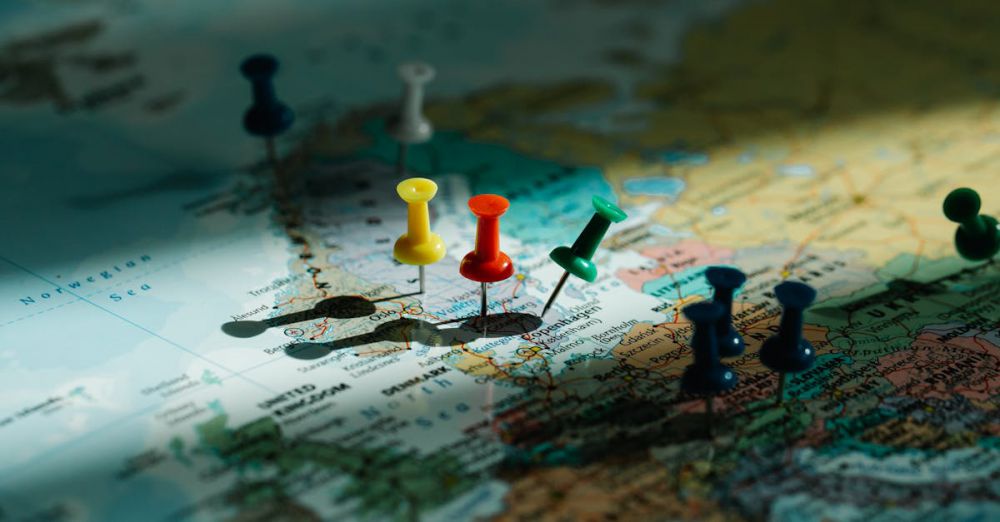 Route Selection - A close-up view of colorful push pins marking locations on a detailed world map.