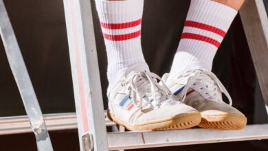 Shoes - Close-up of sneakers and socks on a metal ladder in bright sunlight, emphasizing casual style.