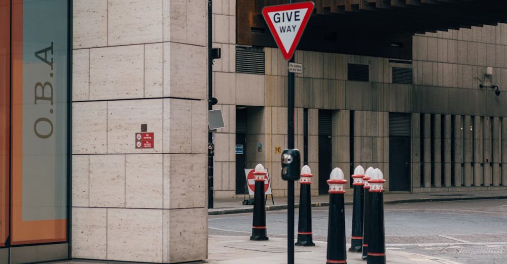 Road Trip Safety - Vintage urban street view featuring 'Give Way' sign in central London.