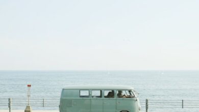 Road Trip Playlist - A classic Volkswagen van driving on a seaside road in Fujisawa, Japan, capturing a nostalgic coastal vibe.