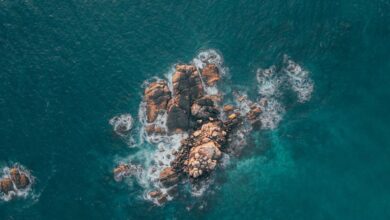 Rocky Photography - Stunning aerial shot of a rocky island surrounded by blue ocean waves in Sri Lanka.