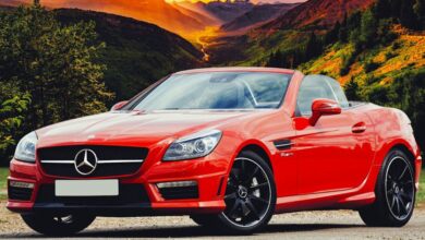 Tour Style - Stunning red Mercedes Benz convertible parked against a breathtaking Scottish sunset backdrop.