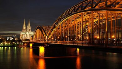 Cologne - Captivating night shot of Cologne Cathedral and Hohenzollern Bridge reflected on the Rhine River.