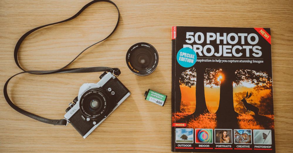 Photography Guide - Vintage film camera with photography project book and accessories on wooden background.