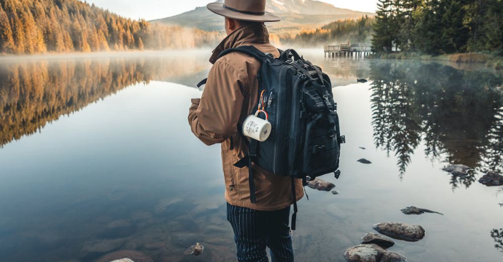 Travel Photography - A hiker with a backpack stands by a tranquil mountain lake, capturing the essence of adventure and serenity.