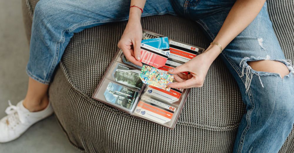 Gift Cards - Female sitting casually organizing various colorful cards in a wallet.