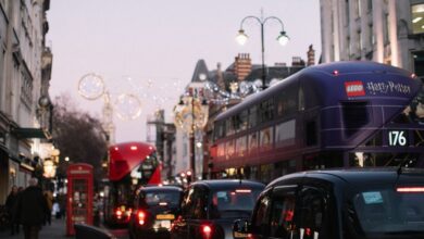 Popular Festivals - Busy London street scene featuring iconic double-decker buses, cars, and city architecture at dusk.