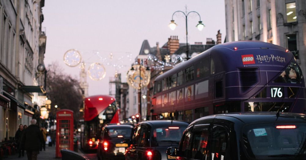 Popular Festivals - Busy London street scene featuring iconic double-decker buses, cars, and city architecture at dusk.