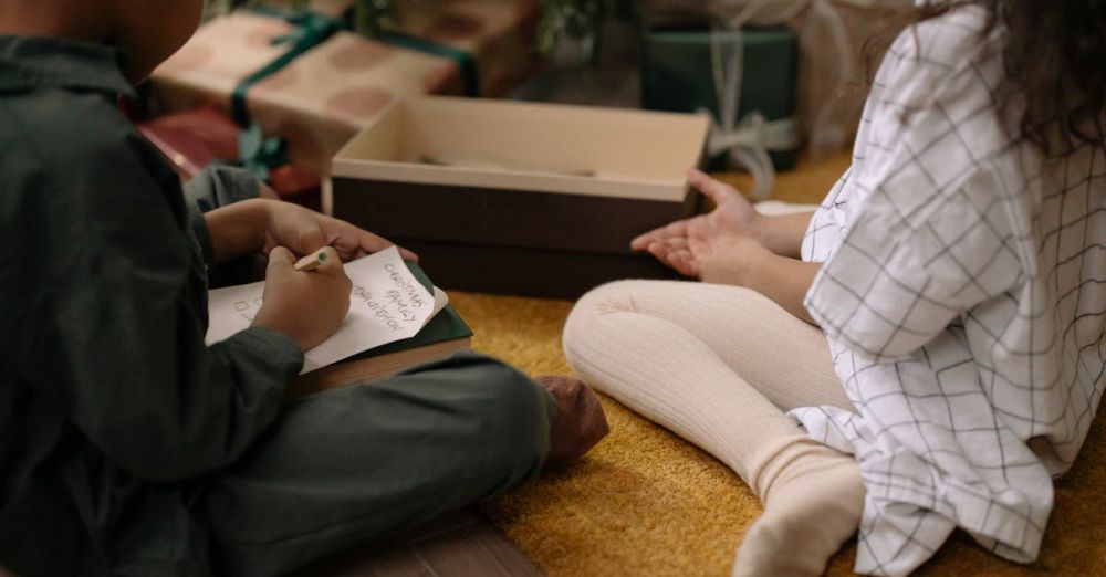 Festival Planning - Two children sit by a Christmas tree writing a holiday to-do list indoors.