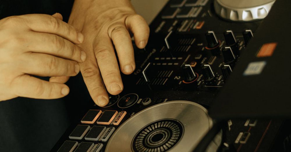 Live Performances - Close-up of DJ hands mixing music on a professional turntable at an event.