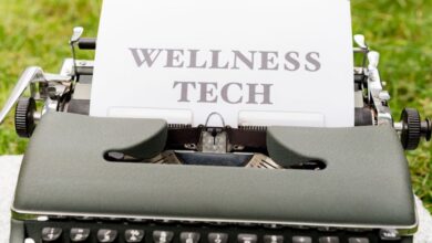 Fitness Trackers - A retro typewriter outdoors displaying a 'Wellness Tech' message on paper.