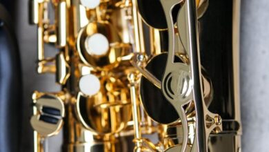 Jazz Festivals - Detailed close-up of a shiny gold saxophone against a concrete backdrop. Perfect for music-related themes.