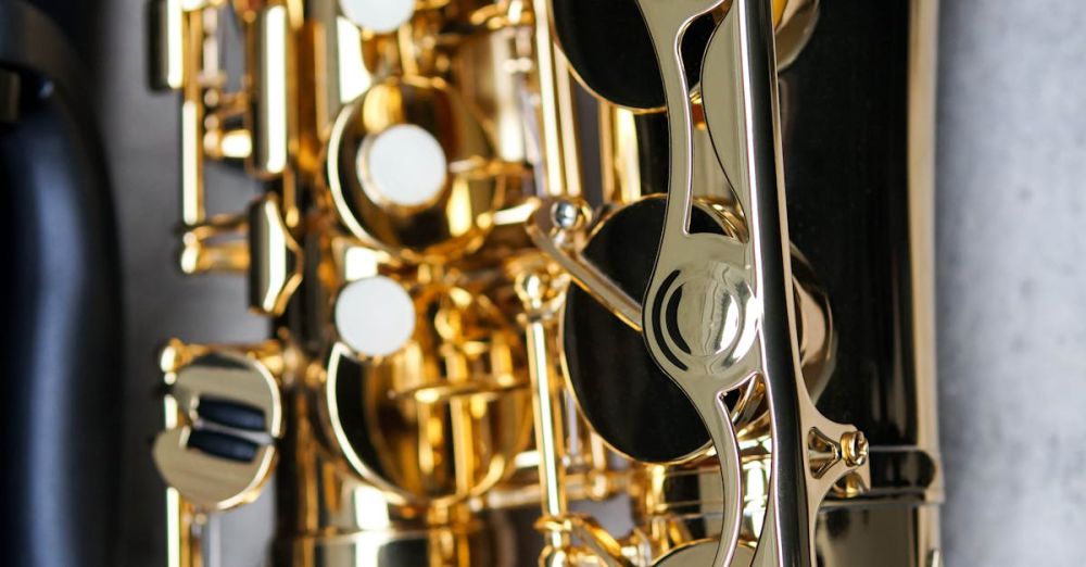 Jazz Festivals - Detailed close-up of a shiny gold saxophone against a concrete backdrop. Perfect for music-related themes.