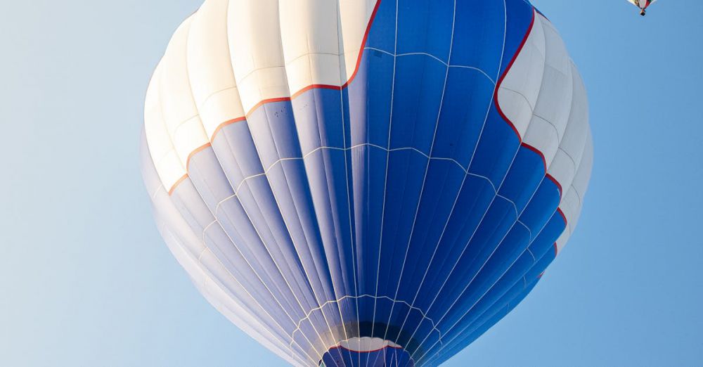 Festival Navigation - Vibrant hot air balloons soar in the clear skies over Albuquerque, New Mexico.