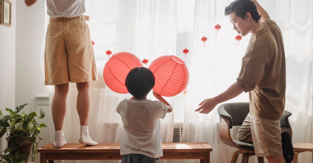 Kids Festivals - Family bonding while decorating their home with red lanterns, capturing a warm and festive atmosphere.