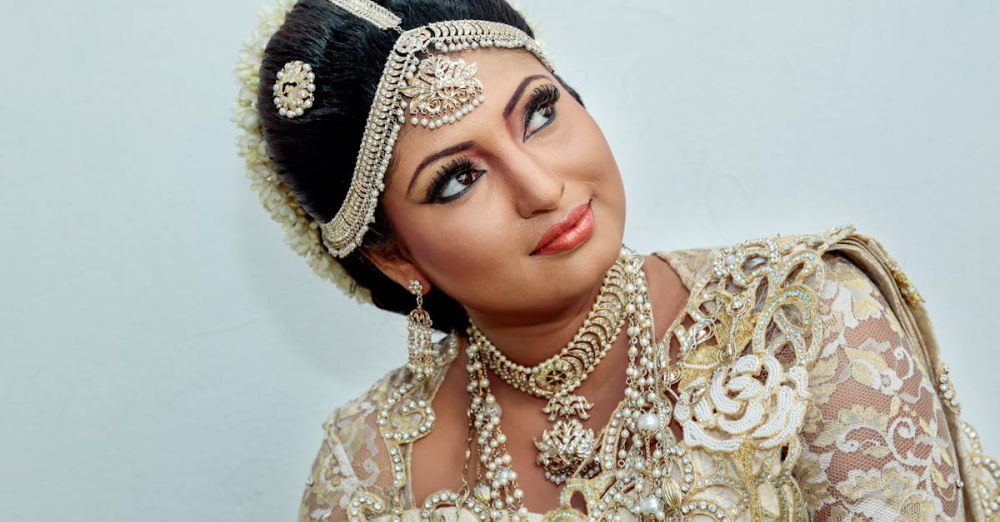 Fashion Festivals - A stunning portrait of a South Asian bride in luxurious traditional attire adorned with intricate jewelry and floral lace.