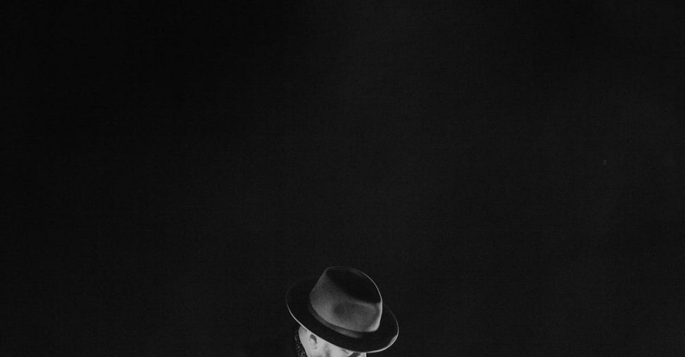 Jazz And Blues Festivals - A captivating black and white image of a guitarist playing onstage under dramatic lighting.