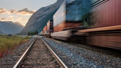 BC Zip Lining - Vivid image of a freight train on tracks beneath majestic mountains in Field, BC.