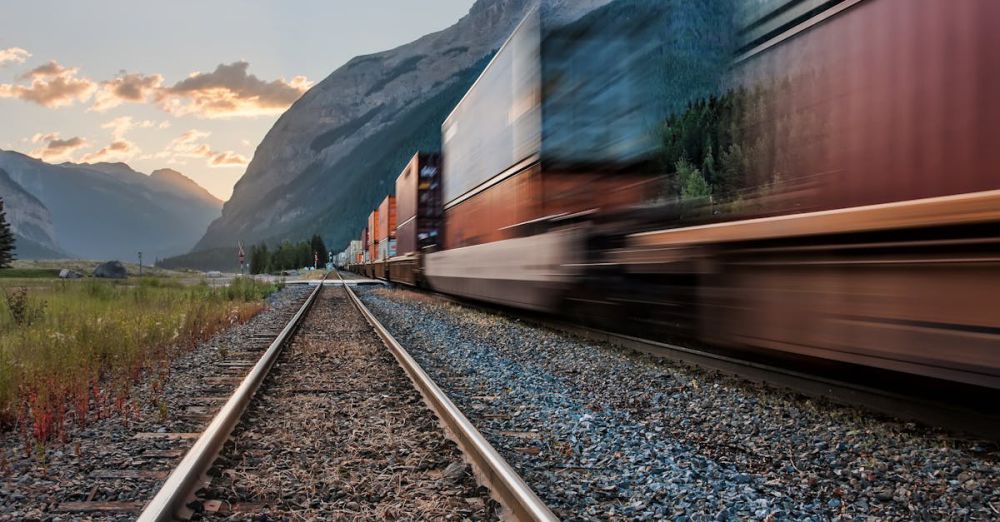 BC Zip Lining - Vivid image of a freight train on tracks beneath majestic mountains in Field, BC.