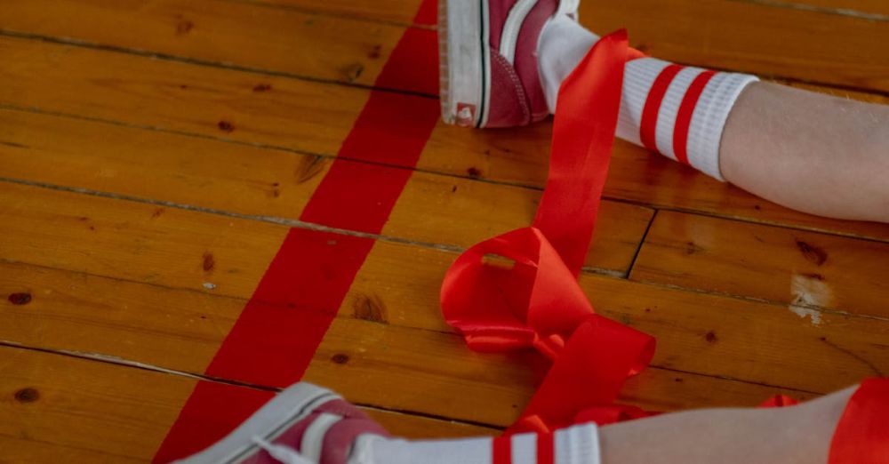 Popular Zip Lining - Close-up of legs in sneakers and ribbons on a gym floor, showcasing casual style.