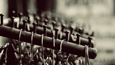 Zip Lining Photography - Stylish black and white photo of metal hangers neatly arranged on a rack, perfect for design concepts.