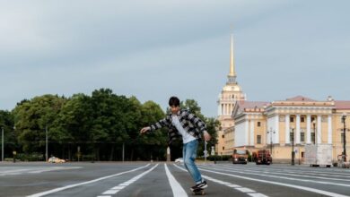 Extreme Zip Lining - A skateboarder rides through Palace Square in Saint Petersburg with Admiralty in the background.