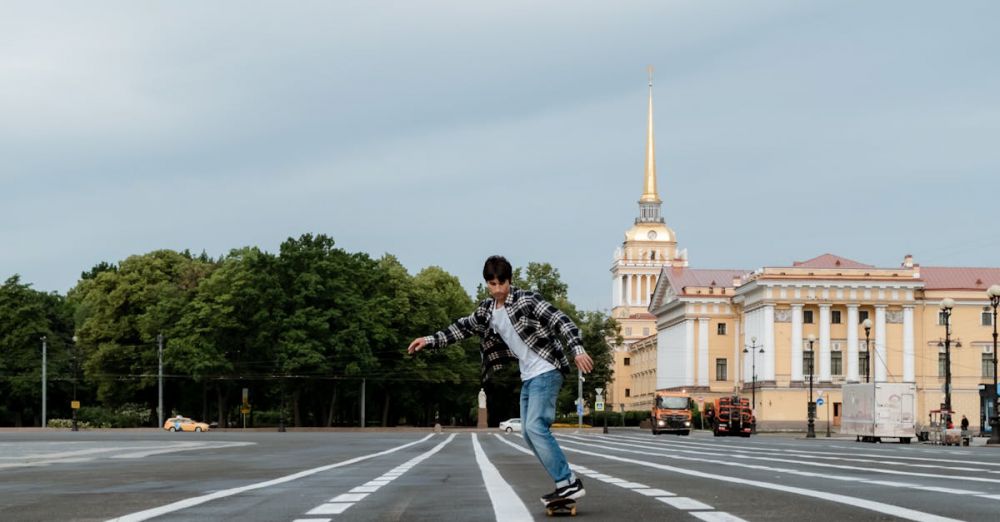 Extreme Zip Lining - A skateboarder rides through Palace Square in Saint Petersburg with Admiralty in the background.