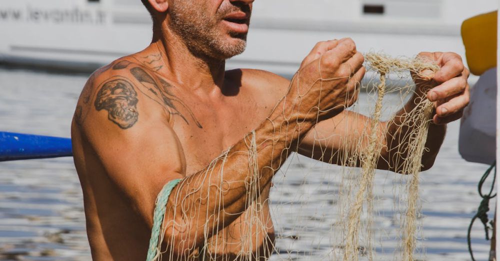 Fishing Techniques - A fisherman repairs a fishing net by the marina, showcasing traditional fishing culture.