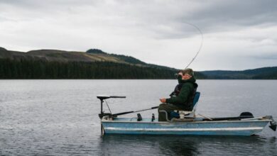 BC Fishing - An old man fishing peacefully on a lake in BC, Canada, amidst beautiful nature.