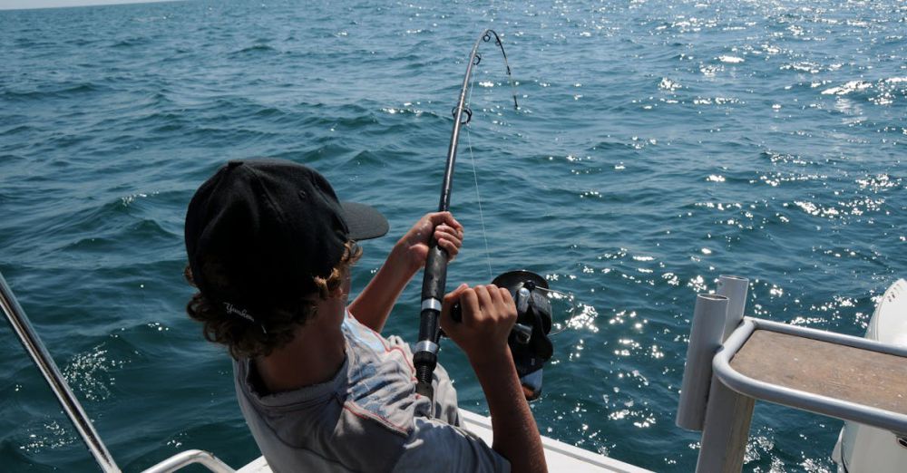 Saltwater Fishing - A young man actively fishing in the ocean near Broome, WA, enjoying a sunny day.