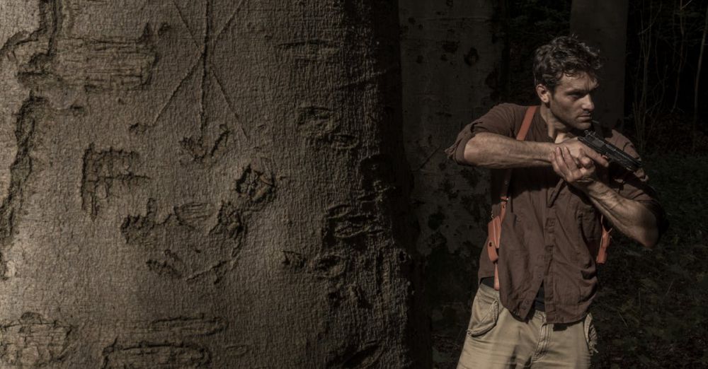 Responsible Hunting - Man camouflaged in forest setting, holding a gun with intent near a tree with carvings.