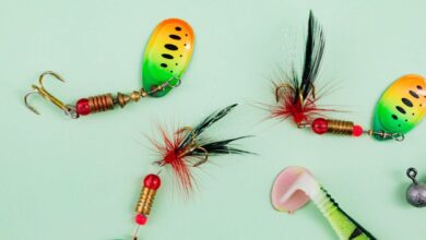 Bass Fishing - Close-up of vibrant fishing lures and hooks on a green backdrop.