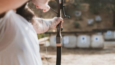 Elk Hunting - Adult practicing archery at outdoor range with traditional bow.