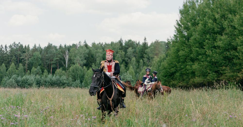 Horseback Riding Tours - Group of cavalry riders in historic uniforms in a lush meadow setting.