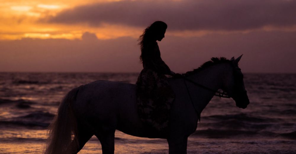 Coastal Horseback Riding - Silhouette of a person riding a horse along a beach in Thailand during a stunning sunset.