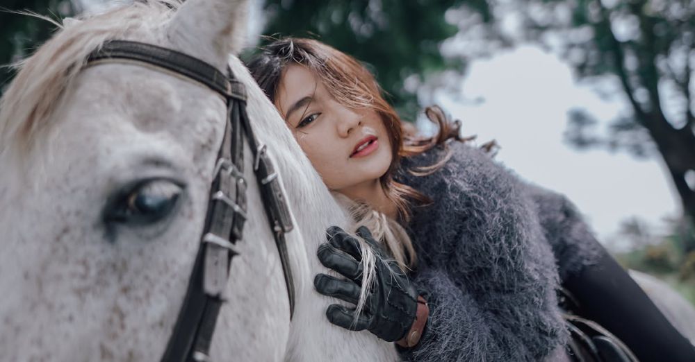 National Park Horseback Riding - Stylish woman on horseback in natural setting, showcasing elegant fashion and thoughtful expression.