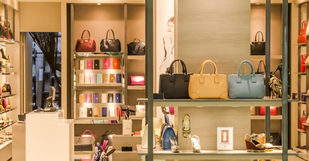 Fashion Accessories - Chic boutique with a variety of handbags and shoes elegantly displayed on shelves.