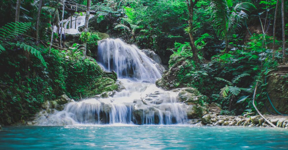 Waterfalls - Captivating tropical waterfall cascading through vibrant jungle greenery, a serene nature escape.