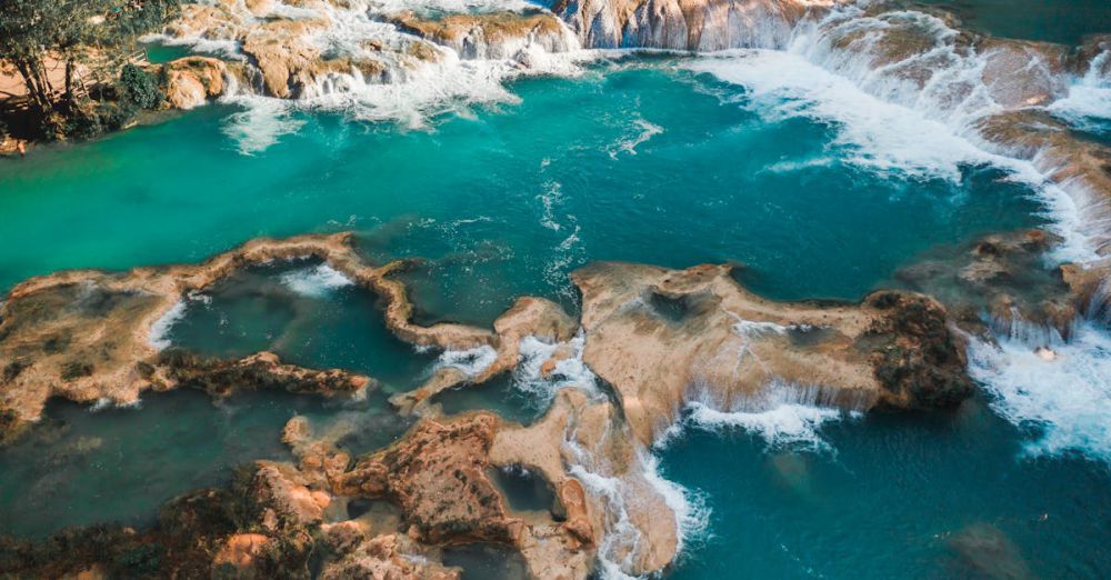 Waterfall Safety - A breathtaking aerial view of stunning turquoise waterfalls amidst lush greenery.