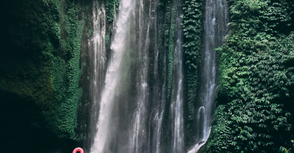 Swimming Waterfalls - A stunning waterfall in a lush tropical rainforest in Indonesia, perfect for travel lovers.