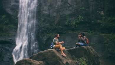 Senior-Friendly Waterfalls - A serene moment captured by a waterfall in India with a couple enjoying nature's beauty together.