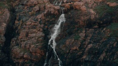 Off The Beaten Path Waterfalls - Breathtaking view of a waterfall cascading down a rocky mountainside in Western Australia.