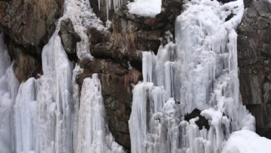 Stunning Waterfalls - Breathtaking view of a frozen waterfall cascading down rocky cliffs during winter.