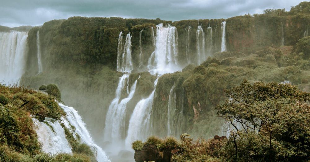 Multi-Waterfall Trip - Breathtaking view of Iguazu Falls in Brazil, surrounded by vibrant rainforest and mist.