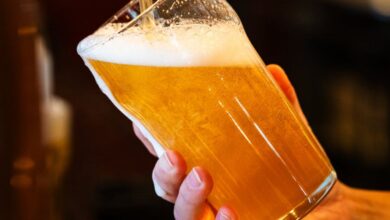 Quebec Vineyard & Brewery Tours - Closeup of a draft beer being poured into a pint glass at a bar in Montreal, Canada.