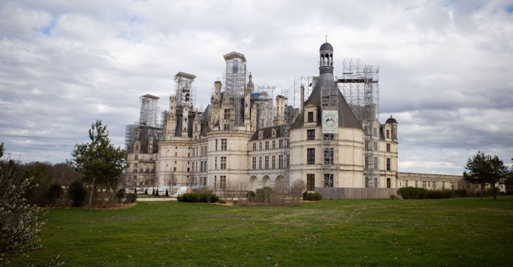 History Tours - Château de Chambord in France, with picturesque clouds and green lawns.