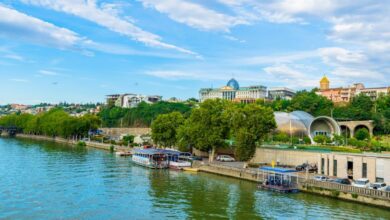 Outdoor Tours - Beautiful riverside showing Tbilisi's vibrant urban architecture with ferries along the canal.