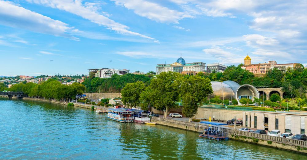 Outdoor Tours - Beautiful riverside showing Tbilisi's vibrant urban architecture with ferries along the canal.