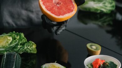 Food Truck Tours - Person preparing a healthy meal with fresh grapefruit, kiwi, and lettuce.