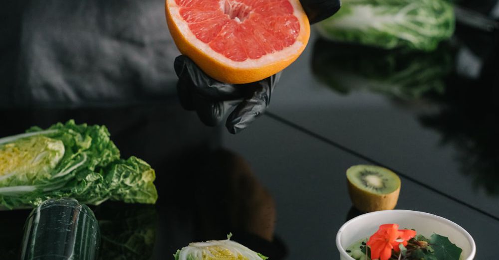 Food Truck Tours - Person preparing a healthy meal with fresh grapefruit, kiwi, and lettuce.